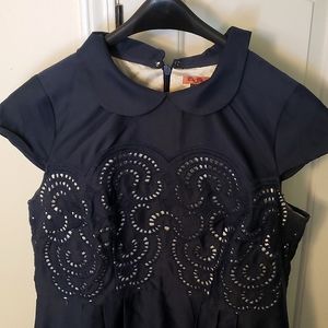 Retro capped sleeved dress. Navy blue w/ eyelet pattern & cream colored lining.